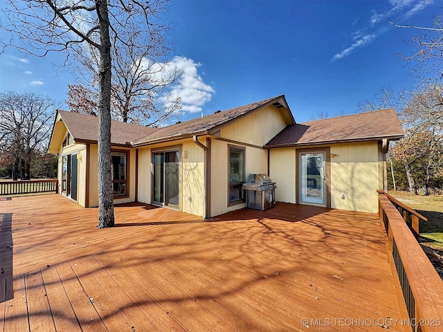 back of house featuring a wooden deck