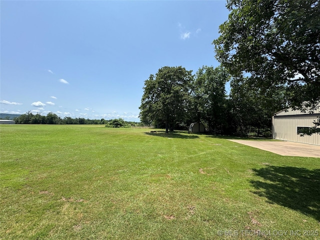 32432 S Skyline Dr, Cookson, OK 74427 - view of green lawn with a storage shed and a patio