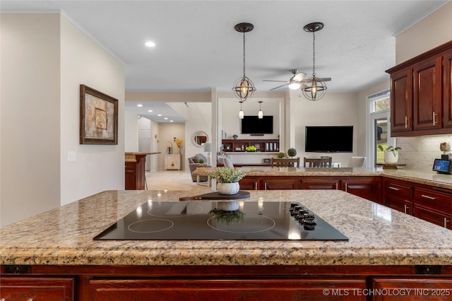 kitchen featuring reddish brown cabinets, tasteful backsplash, open floor plan, black electric stovetop, and pendant lighting