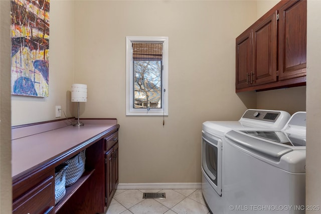 laundry area with cabinet space, baseboards, visible vents, separate washer and dryer, and light tile patterned flooring