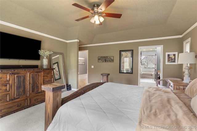 carpeted bedroom featuring ornamental molding, a raised ceiling, connected bathroom, and ceiling fan