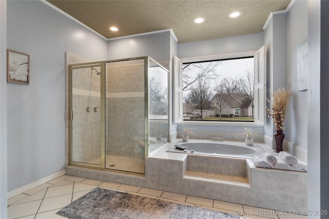 full bathroom featuring a stall shower, a textured ceiling, a bath, and tile patterned floors