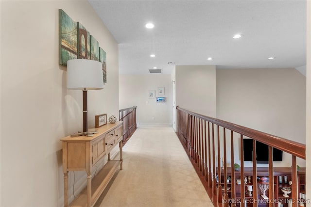 corridor with light carpet, baseboards, and recessed lighting