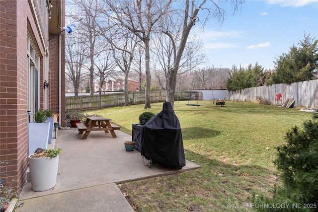 view of yard featuring an outdoor fire pit, a patio area, and a fenced backyard