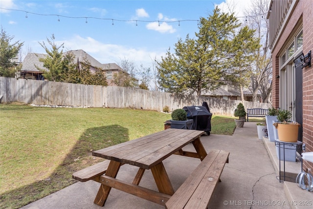 view of patio / terrace with outdoor dining area, a fenced backyard, and area for grilling