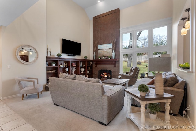 tiled living room featuring high vaulted ceiling, a fireplace, and baseboards