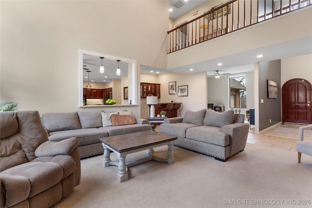 living area with light carpet, visible vents, baseboards, ceiling fan, and recessed lighting