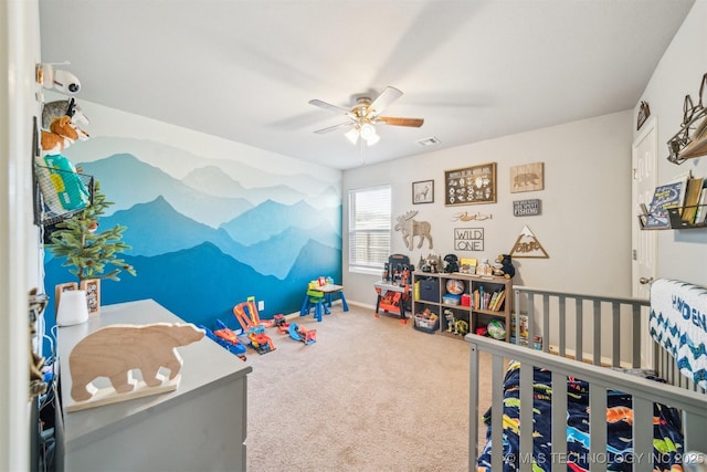 carpeted bedroom with visible vents, baseboards, and a ceiling fan