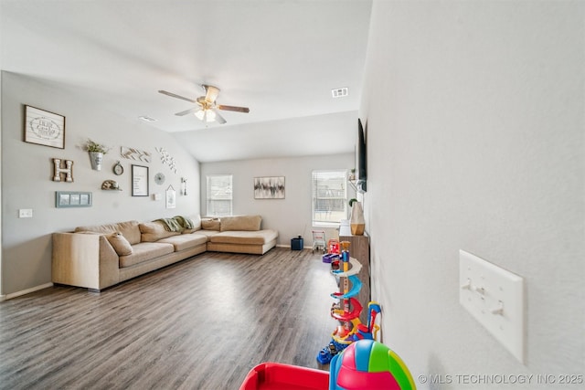 living room with visible vents, vaulted ceiling, ceiling fan, wood finished floors, and baseboards