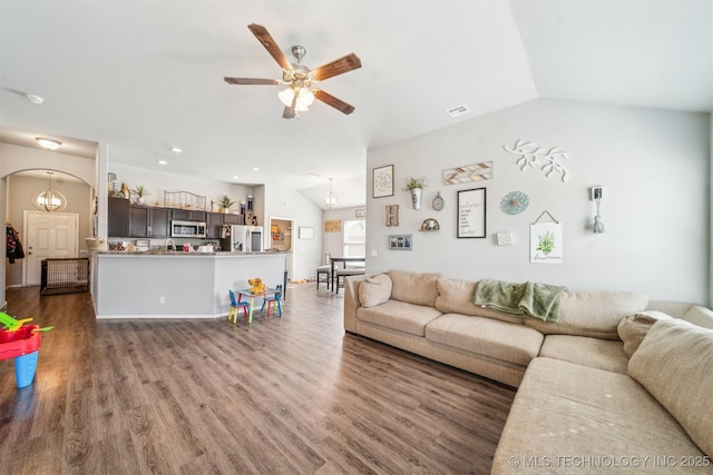 living room featuring visible vents, arched walkways, a ceiling fan, lofted ceiling, and wood finished floors