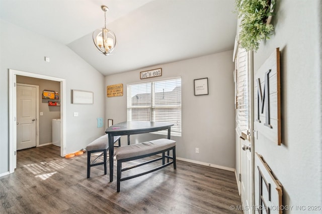 dining room featuring baseboards, vaulted ceiling, wood finished floors, and a chandelier