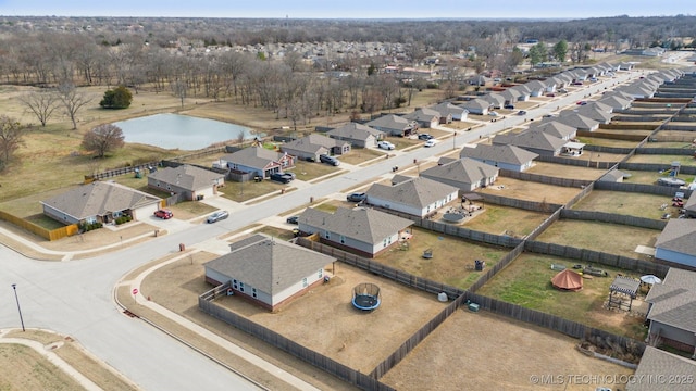 drone / aerial view with a water view and a residential view