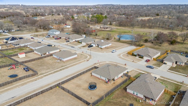 birds eye view of property with a water view and a residential view