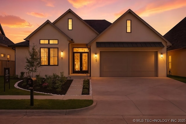 12030 S Vandalia Ave, Tulsa, OK 74137 - view of front of property with stucco siding, concrete driveway, a standing seam roof, and a metal roof