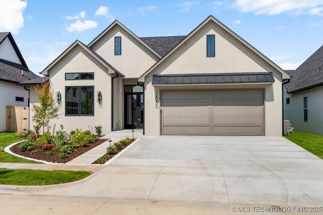 12030 S Vandalia Ave, Tulsa, OK 74137 - view of front facade featuring stucco siding, driveway, and a garage