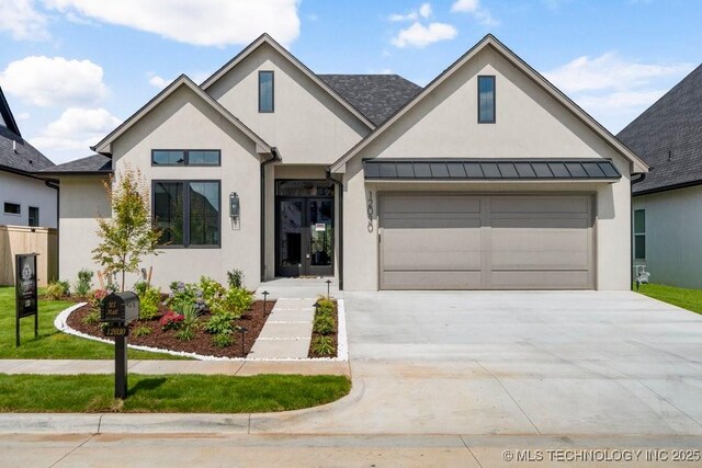 12030 S Vandalia Ave, Tulsa, OK 74137 - view of front facade with stucco siding, driveway, a standing seam roof, and a garage