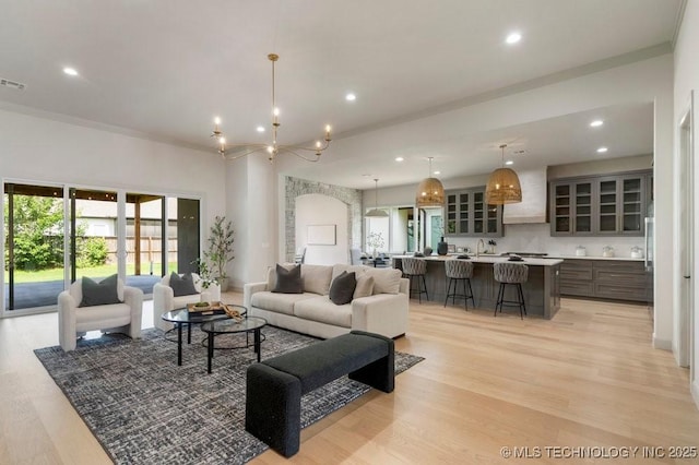 12030 S Vandalia Ave, Tulsa, OK 74137 - living room featuring light wood finished floors, recessed lighting, and a chandelier