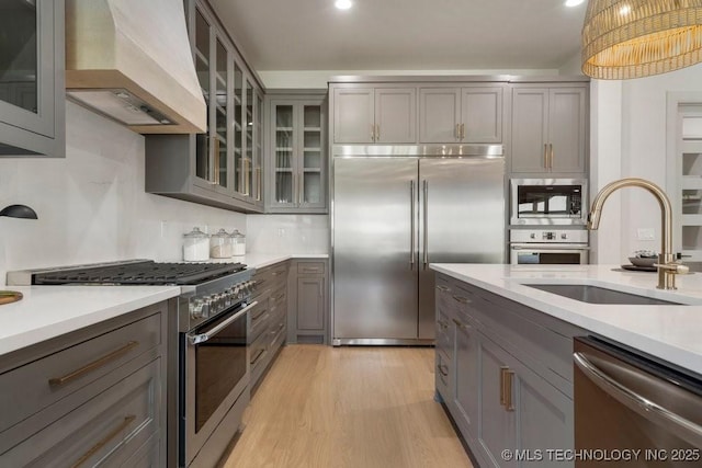 12030 S Vandalia Ave, Tulsa, OK 74137 - kitchen with premium appliances, premium range hood, gray cabinetry, light countertops, and recessed lighting