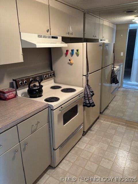 kitchen featuring white electric stove, light floors, gray cabinets, light countertops, and under cabinet range hood