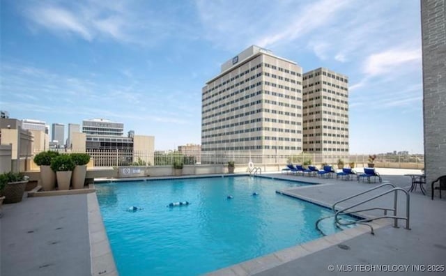 pool with a view of city and a patio