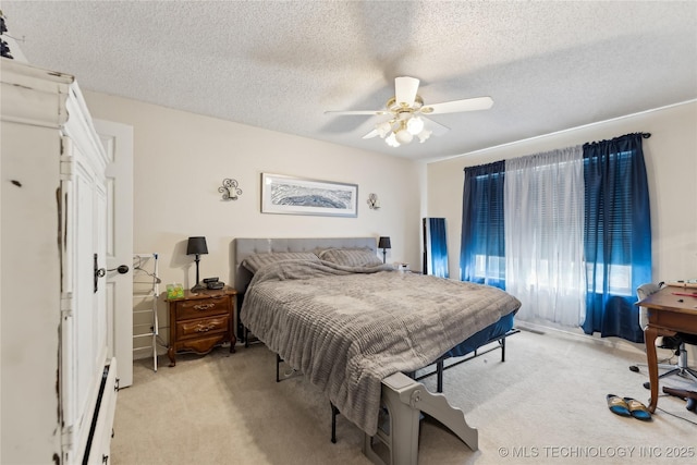 bedroom featuring a ceiling fan, a baseboard radiator, light carpet, and a textured ceiling