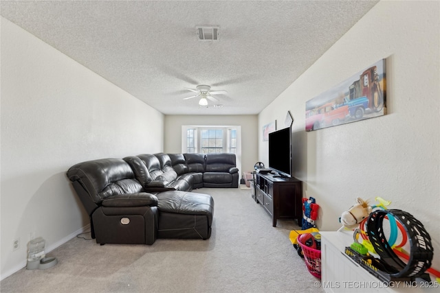 living area featuring light colored carpet, visible vents, ceiling fan, a textured ceiling, and baseboards