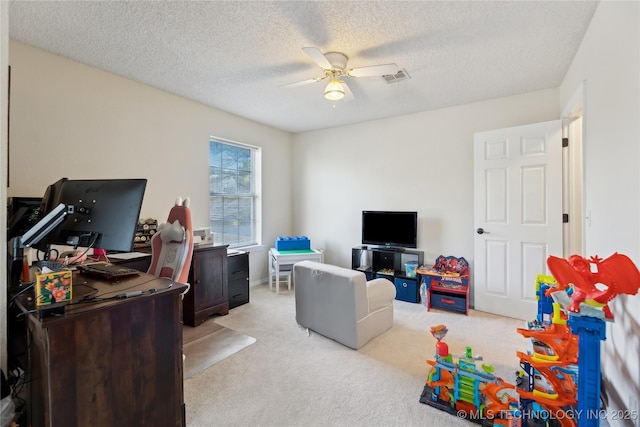 interior space with light carpet, ceiling fan, visible vents, and a textured ceiling