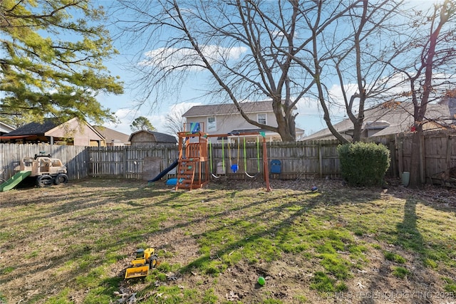 view of yard featuring a fenced backyard and a playground