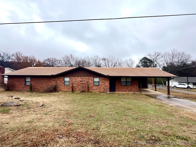 view of front of property featuring concrete driveway, an attached carport, a front yard, and brick siding