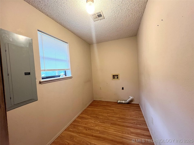 laundry area with hookup for an electric dryer, laundry area, washer hookup, wood finished floors, and electric panel