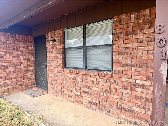 entrance to property with brick siding