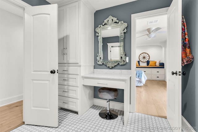 bathroom with ceiling fan, visible vents, and baseboards