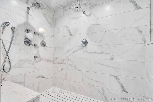 bathroom with a tile shower