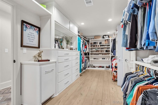 spacious closet with light wood finished floors and visible vents