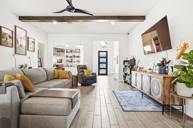 living room with visible vents, a ceiling fan, beam ceiling, and wood finish floors