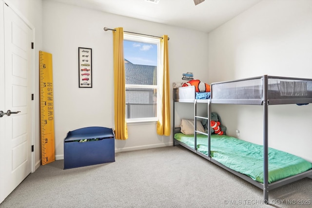 carpeted bedroom featuring baseboards