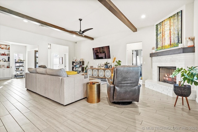 living room featuring recessed lighting, a fireplace, a ceiling fan, light wood-style floors, and beamed ceiling