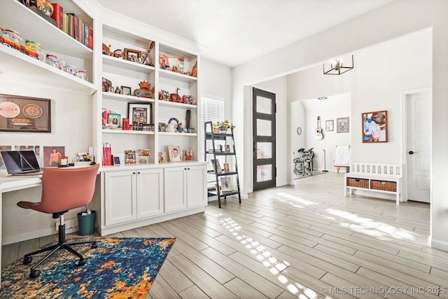 office space with light wood-type flooring and built in study area