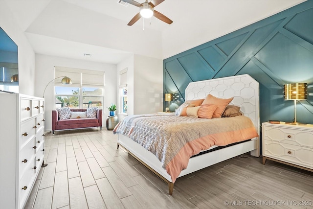 bedroom with a ceiling fan and wood tiled floor