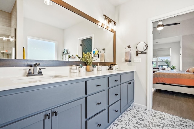 bathroom featuring tile patterned floors, double vanity, a sink, and ensuite bathroom