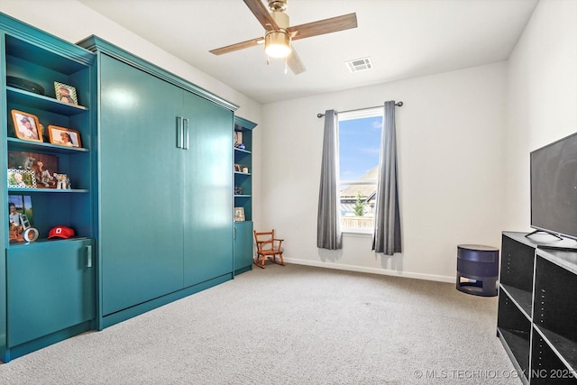 carpeted bedroom featuring ceiling fan, visible vents, and baseboards