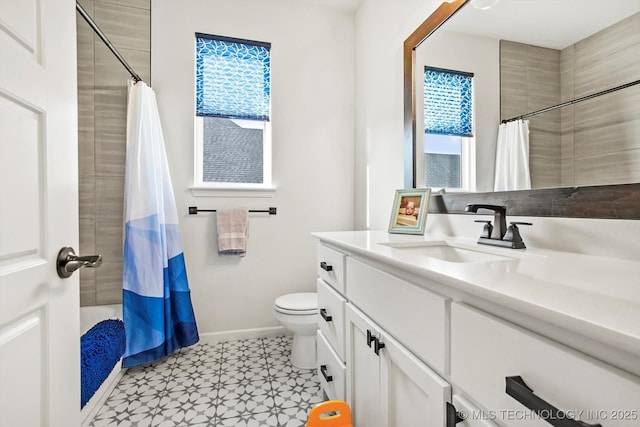 full bath featuring toilet, tile patterned floors, baseboards, and vanity