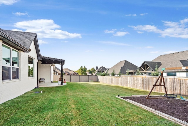 view of yard featuring a patio area, a fenced backyard, and a residential view