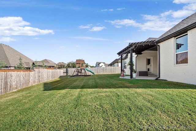 view of yard with a playground, a patio area, a fenced backyard, and a pergola