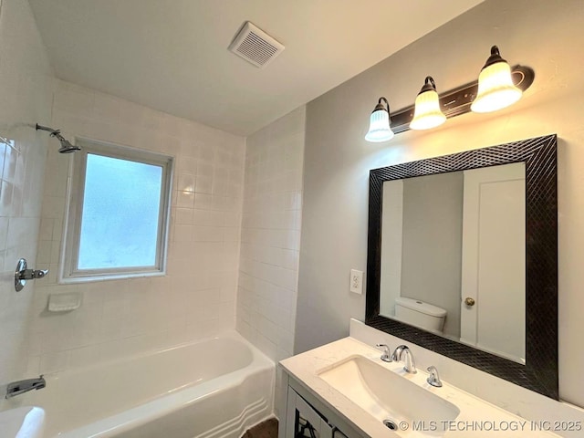 full bathroom with bathtub / shower combination, visible vents, vanity, and toilet