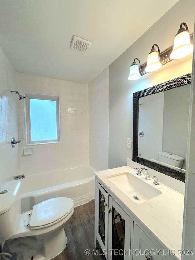 full bath with visible vents, wood finished floors, and toilet