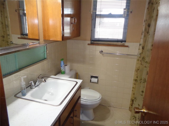 bathroom with toilet, tile patterned floors, and vanity