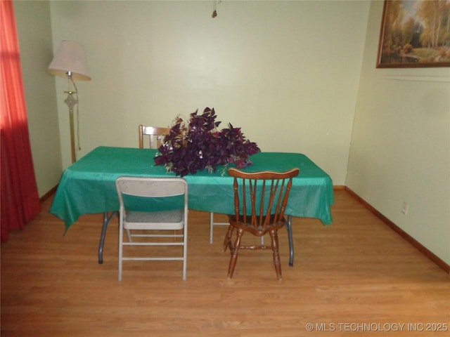 dining room with light wood-style floors and baseboards