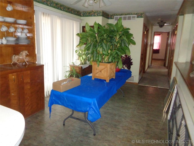 sitting room with visible vents and a ceiling fan