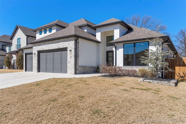 view of front of house with driveway, stone siding, an attached garage, a front lawn, and stucco siding